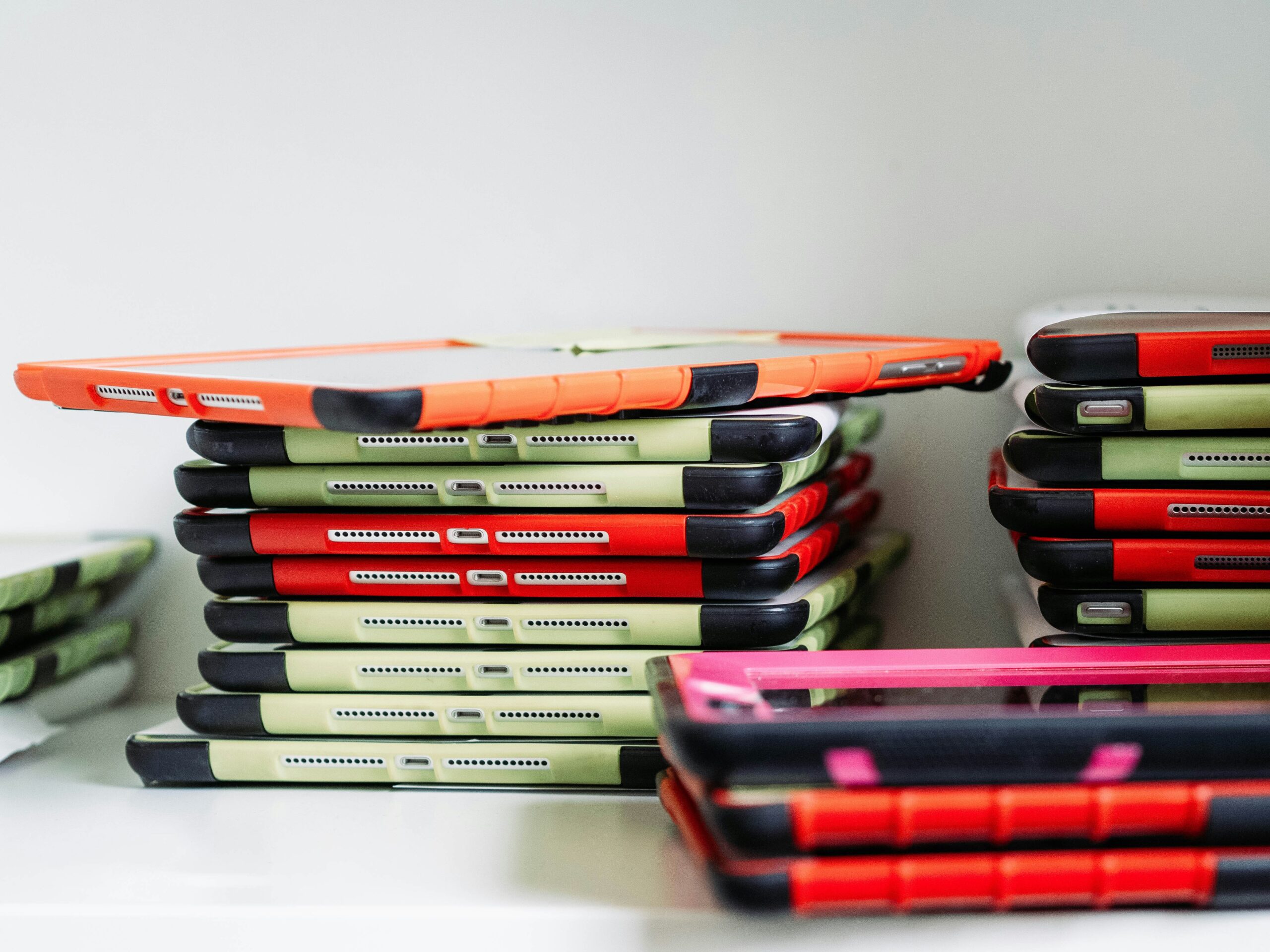 Laptops and smartphones with a fading 'Tariff Exempt' stamp, indicating temporary relief from tariffs.